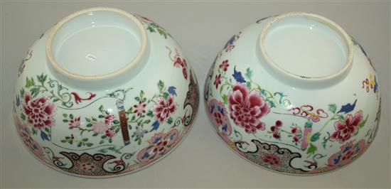 A pair of Chinese famille rose bowls, Qianlong period, 23.3cm, some faults, wood stands
